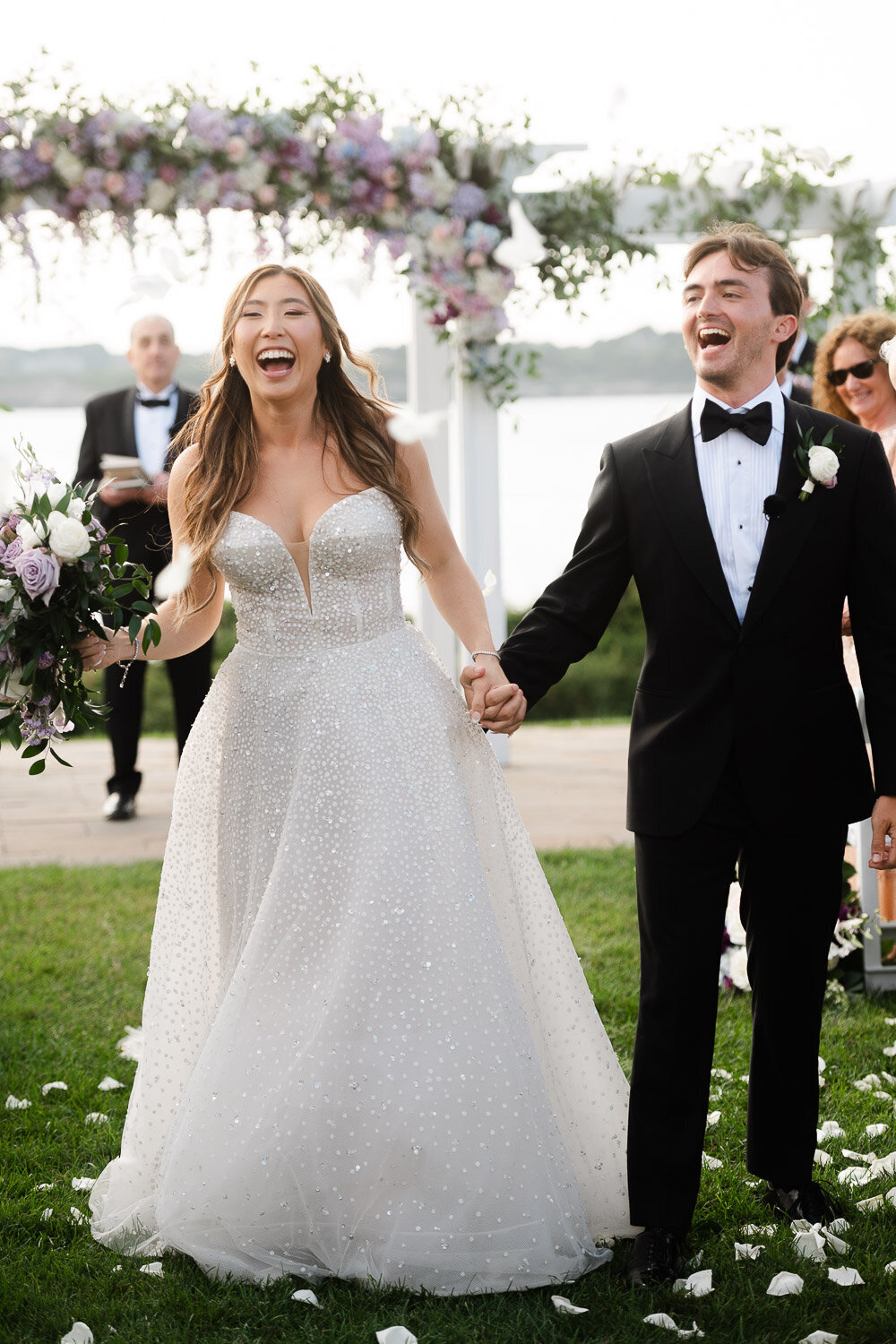 bride and groom laugh down recessional aisle