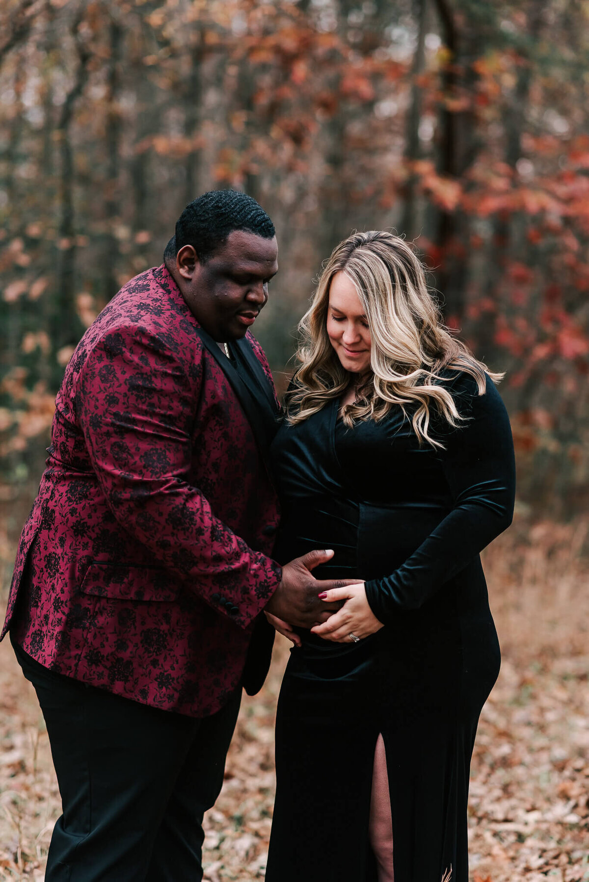An expecting couple feeling their baby kicking during their maternity session in northern Virginia