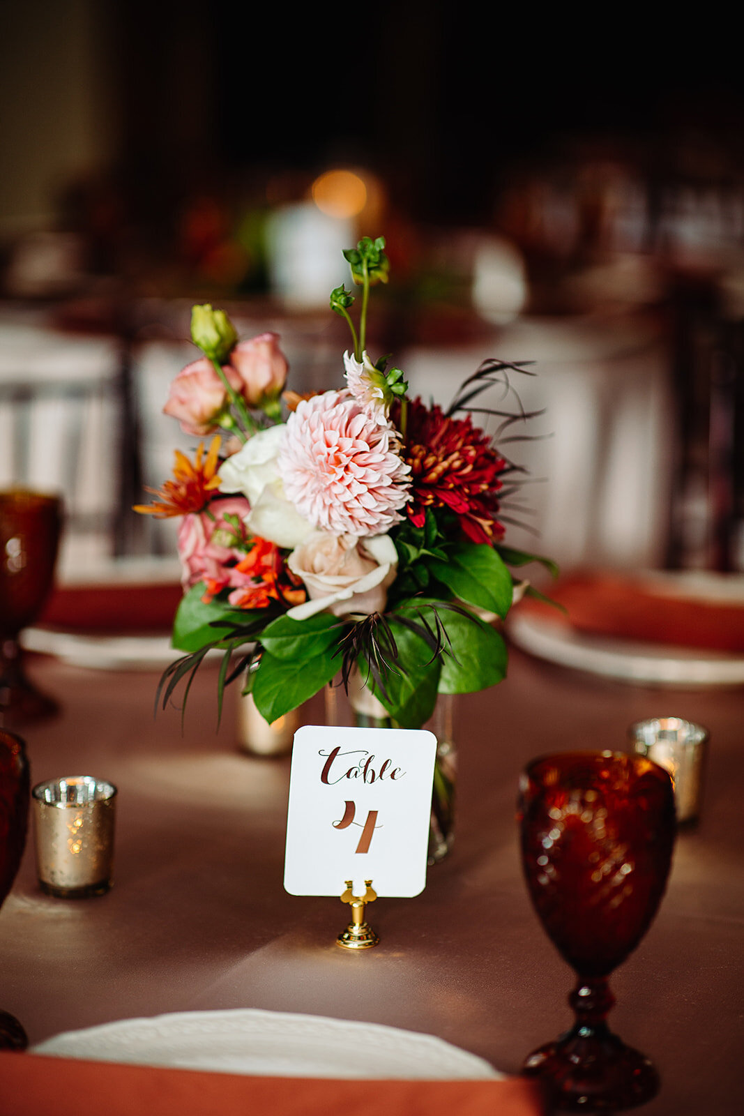 Table setting at Lionsgate Event Center with pink, peach, rust, and gold  colors.