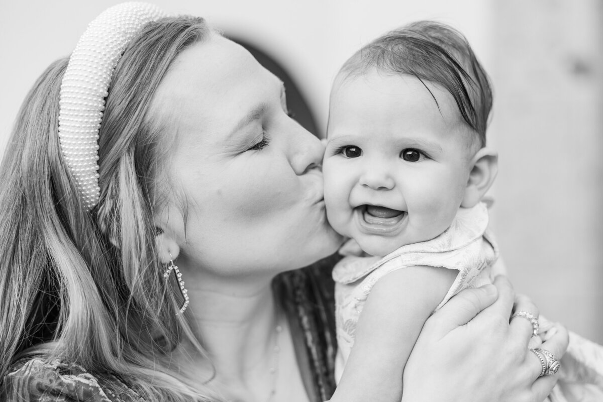 mom-kissing-her-baby-girl-in-black-and-white