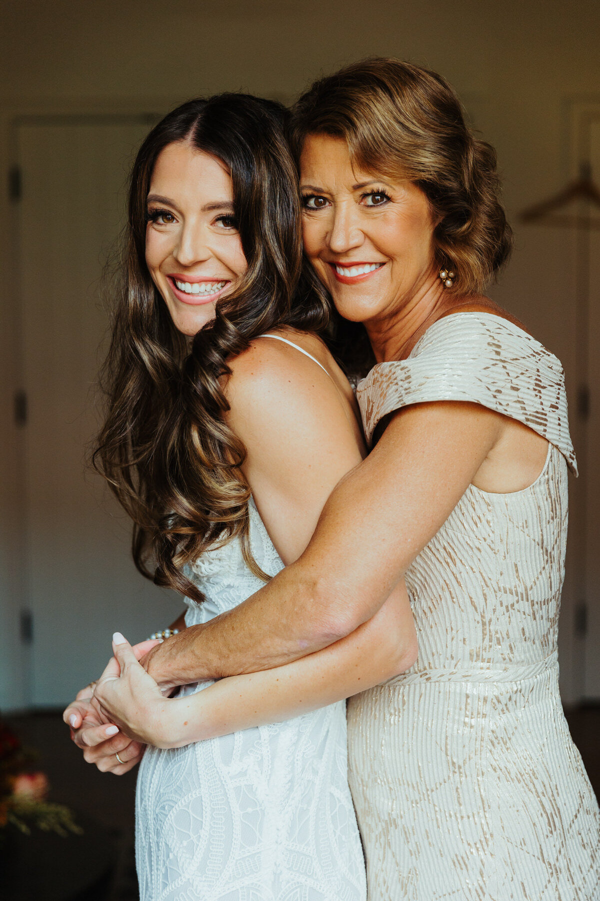 mom and bride embrace on the wedding day