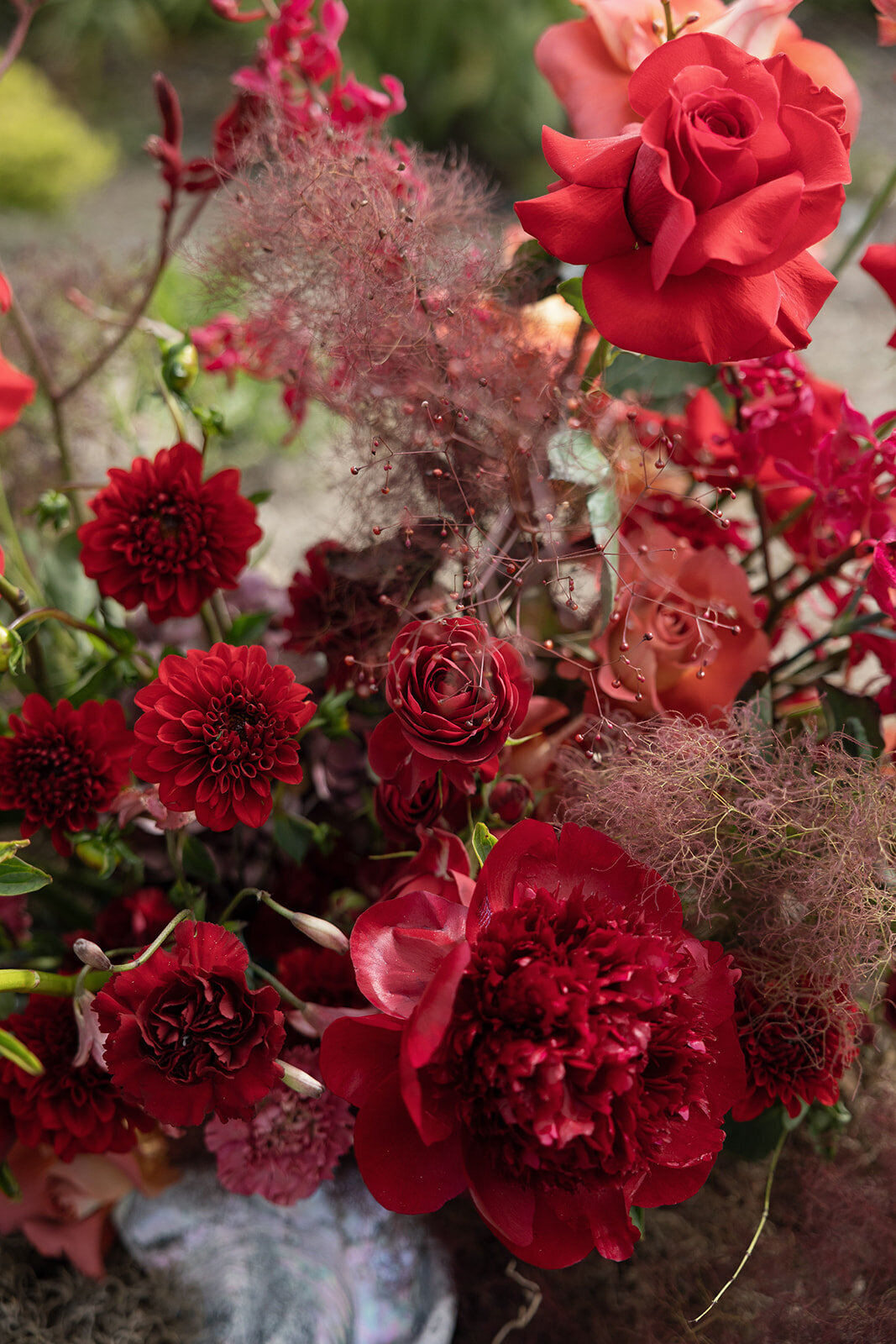 Close-up of a deep red floral bouquet with roses and peonies