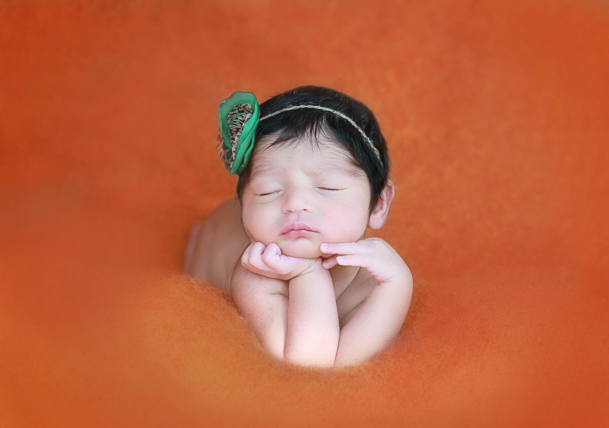 Newborn baby posing on her tummy at home photo session in Calgary Alberta