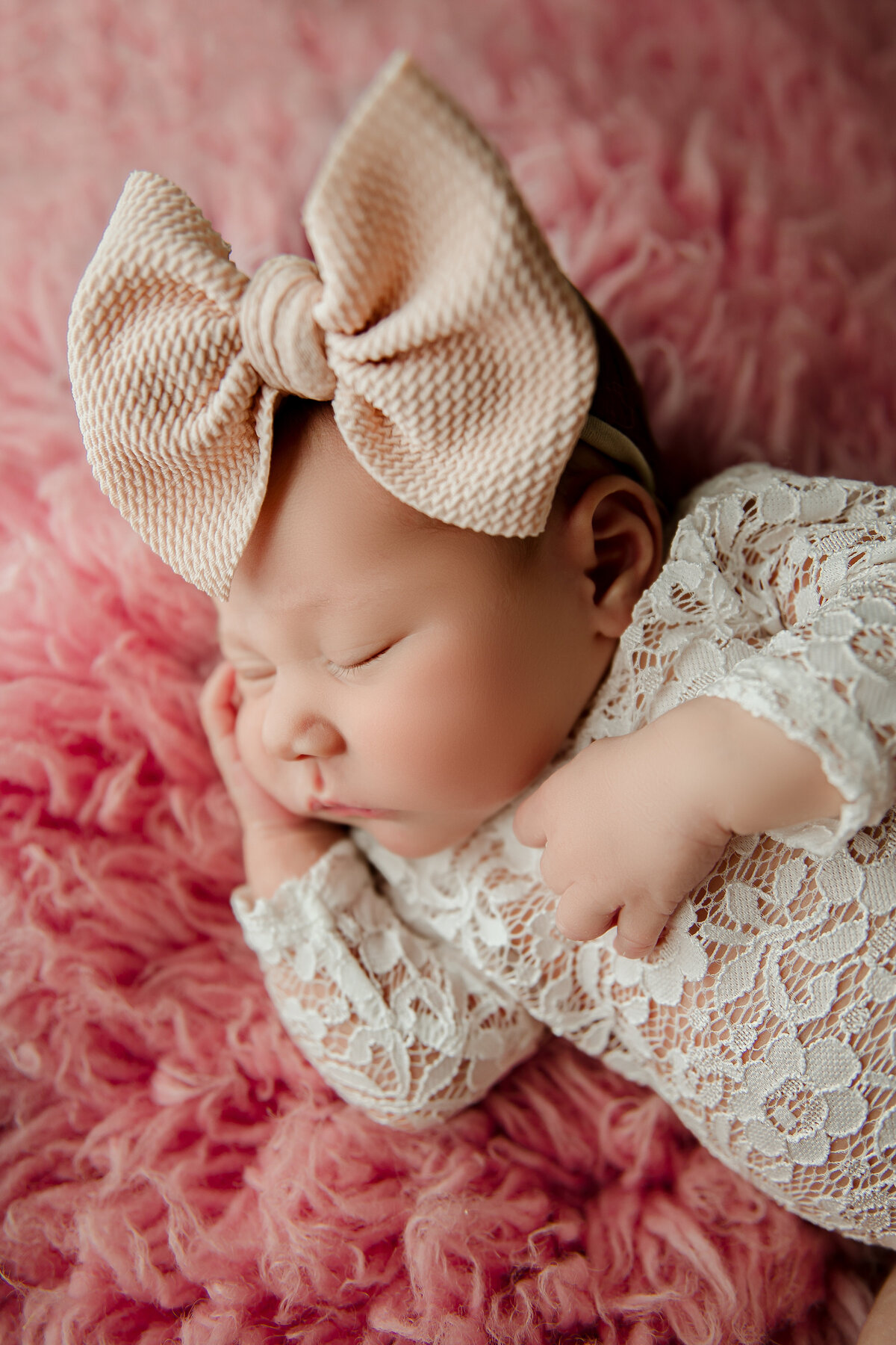newborn girl wearing lace outfit