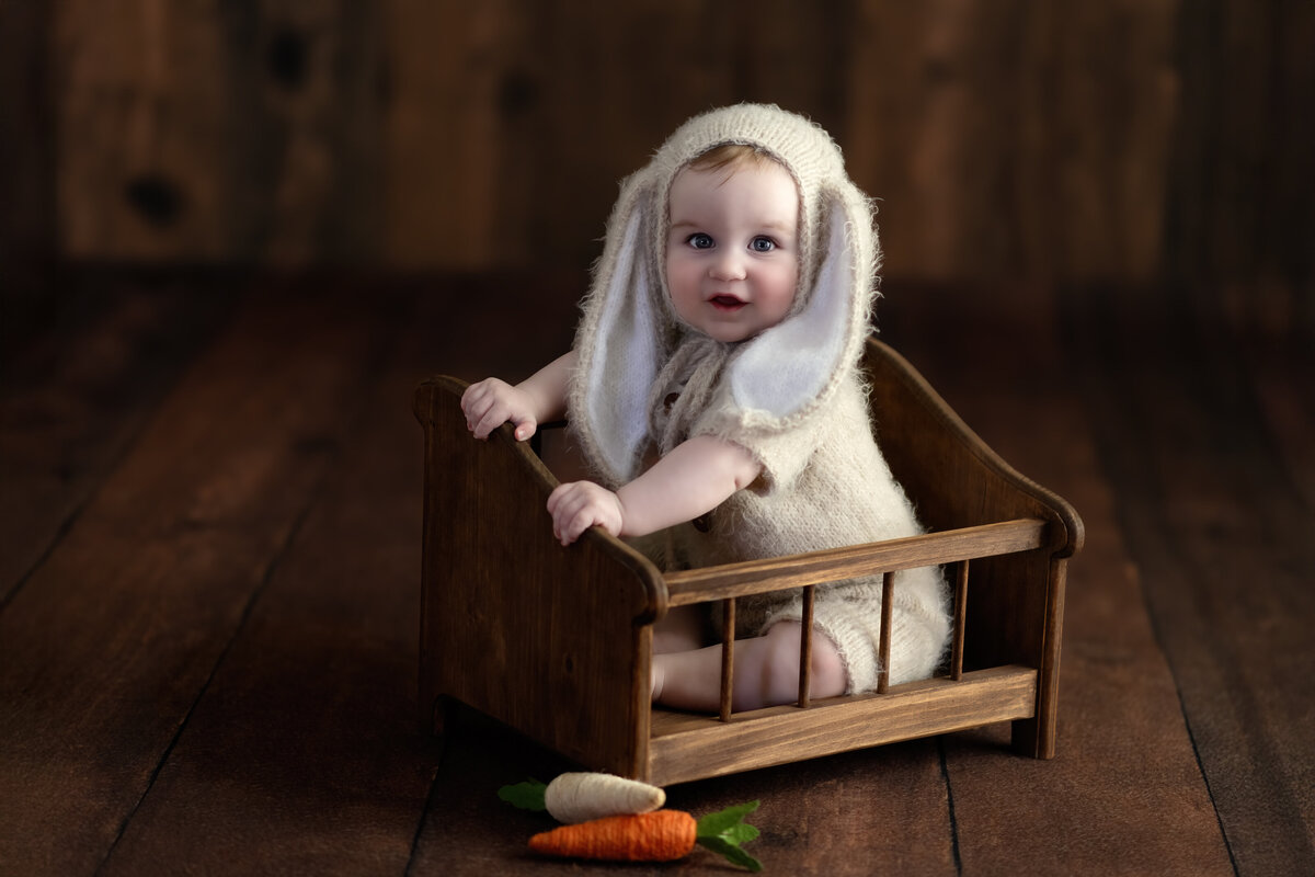 Milestone baby portrait in Paris, Ontario – featuring a sweet bunny bonnet and rustic styling that highlights the magic of childhood.