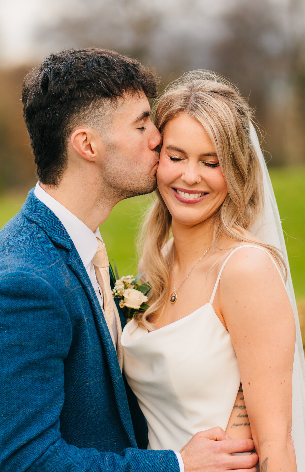 Groom kissing his bride in the gardens at Mytton Fold Hotel  takne by Wedding photographer and videopgrapher Anthony Horseman