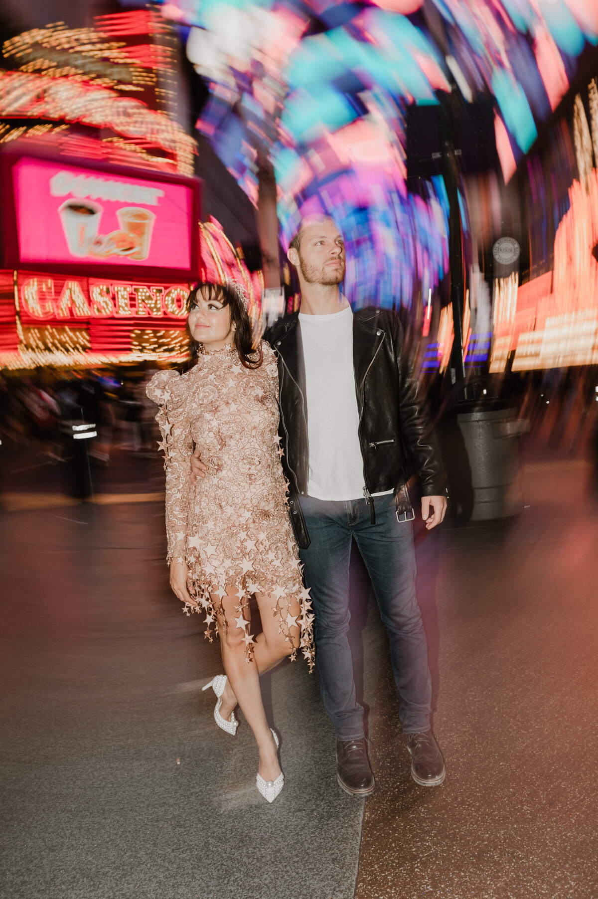 a bride and groom hit the streets of las vegas nevada on fremont street experience with their elopement photographer