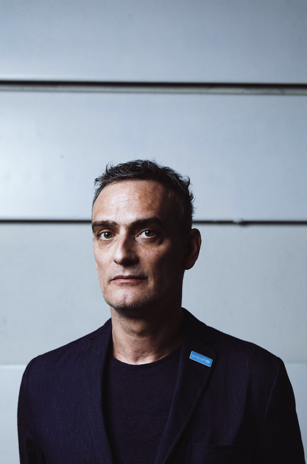 A gritty, stylized moment with filmic grain and ambient light.