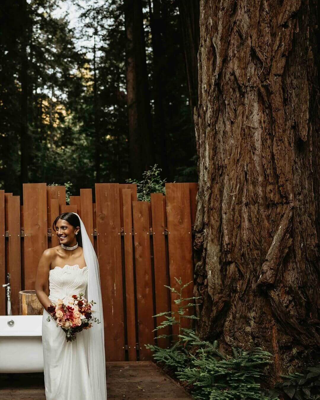 Bride holding a bouquet featuring premium blooms in moody colors at Glen Oaks Big Sur