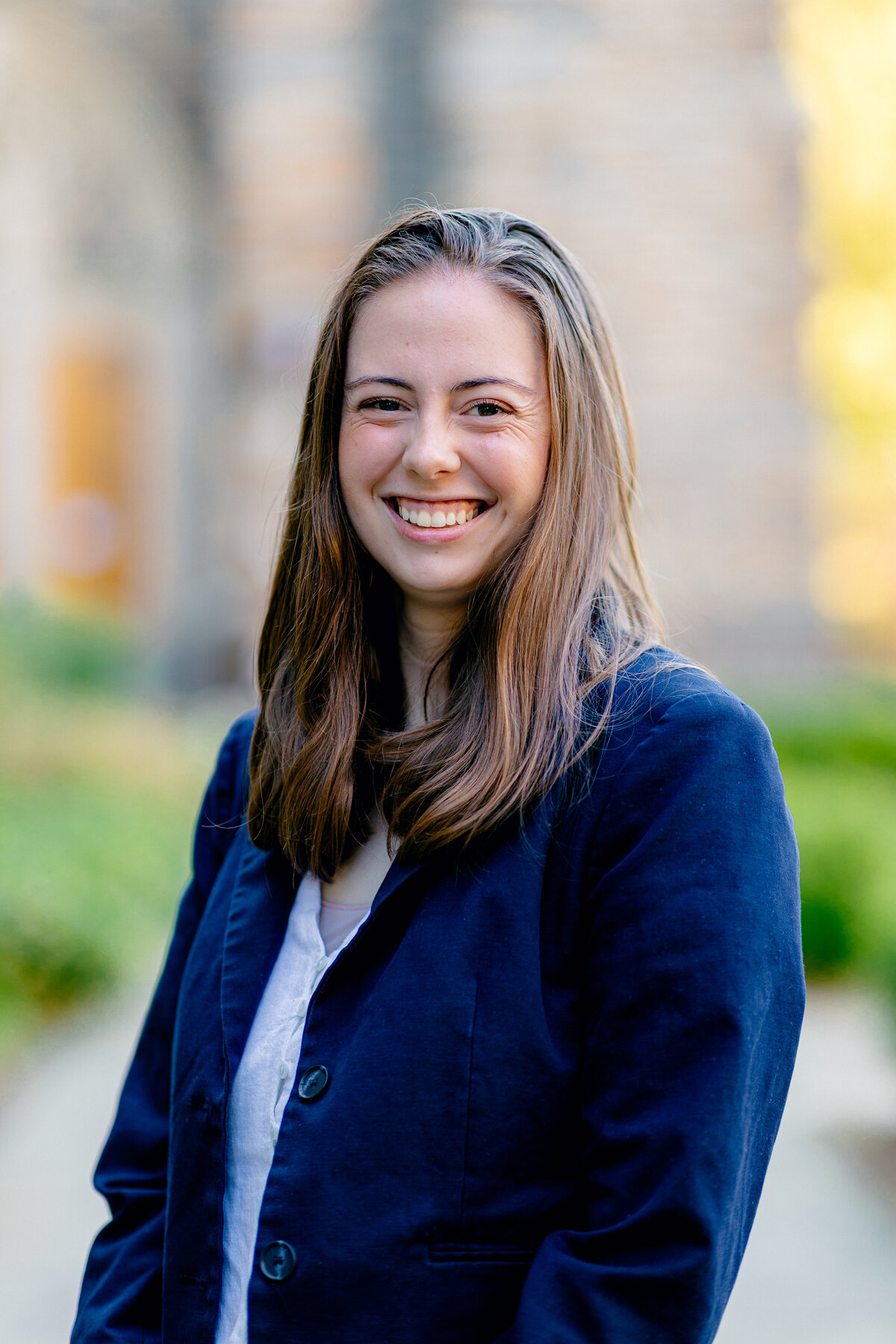 Woman smiling with blue jacket on for headshot