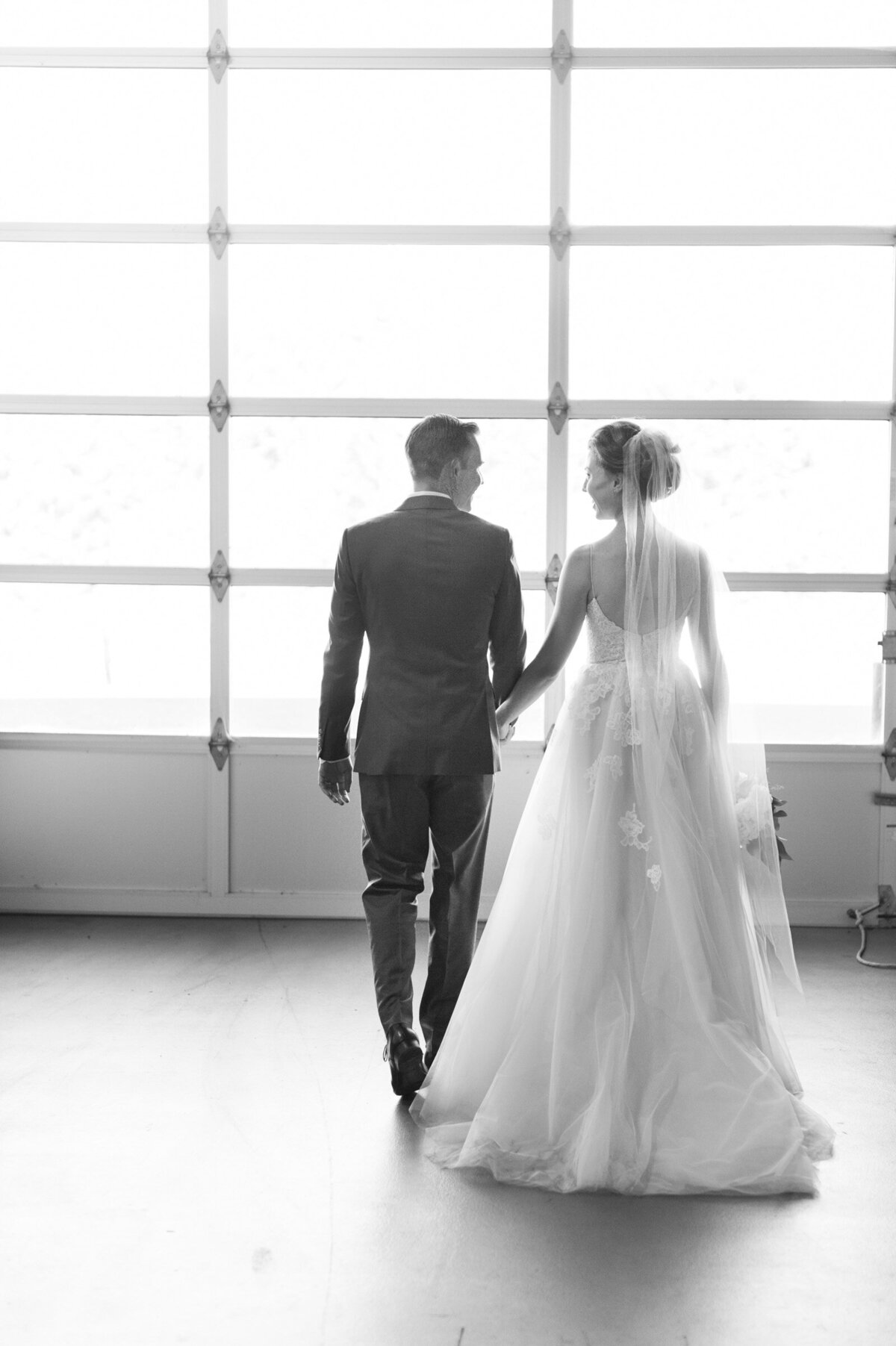 bride and groom walking at ponzi vineyard