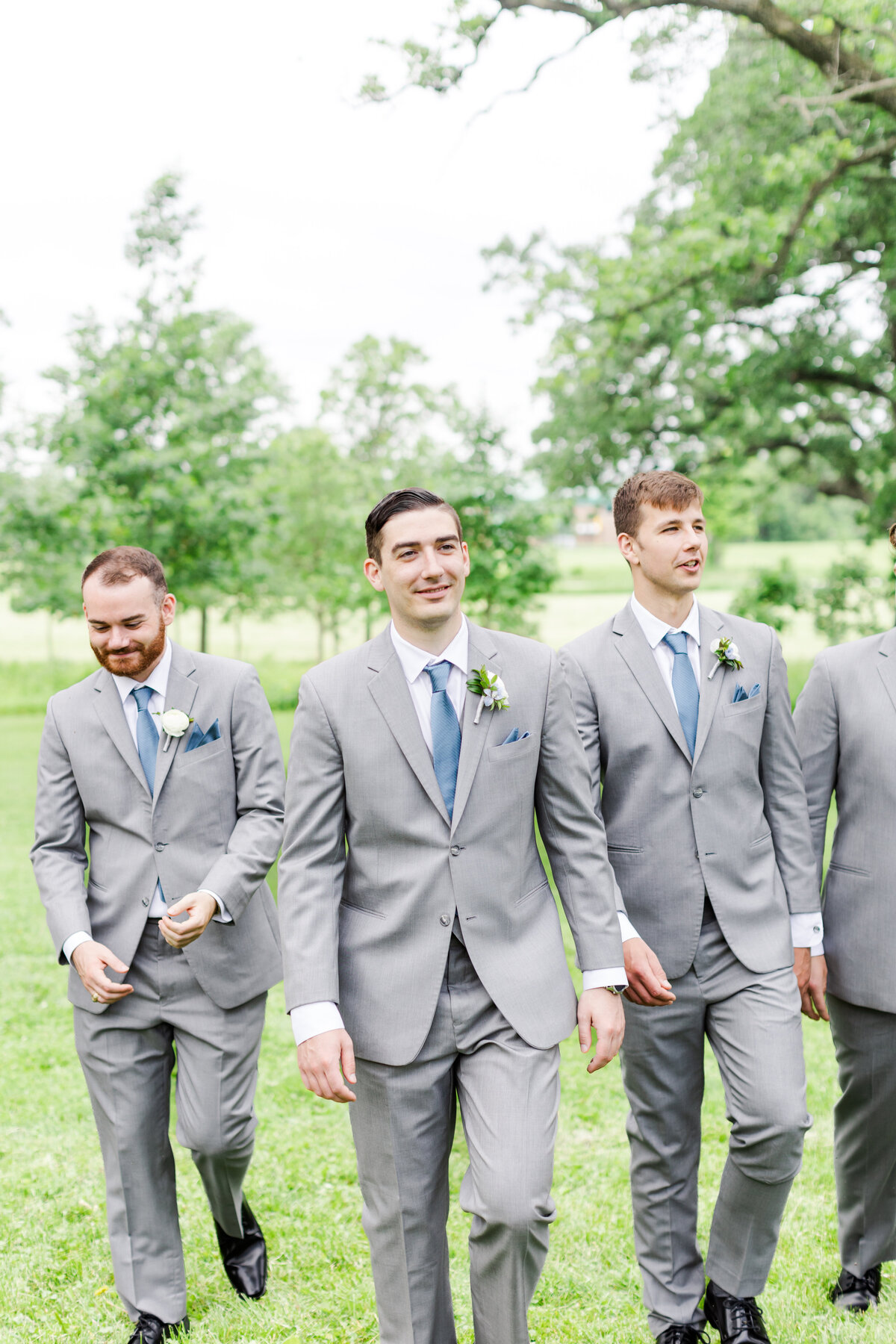 15_olin_park_groomsmen_walking_laughing_image