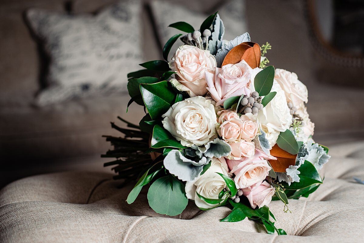 blush, ivory, soft blue and gray bridal bouquet with greenery and magnolia leaves for a fall wedding at Sycamore Farms