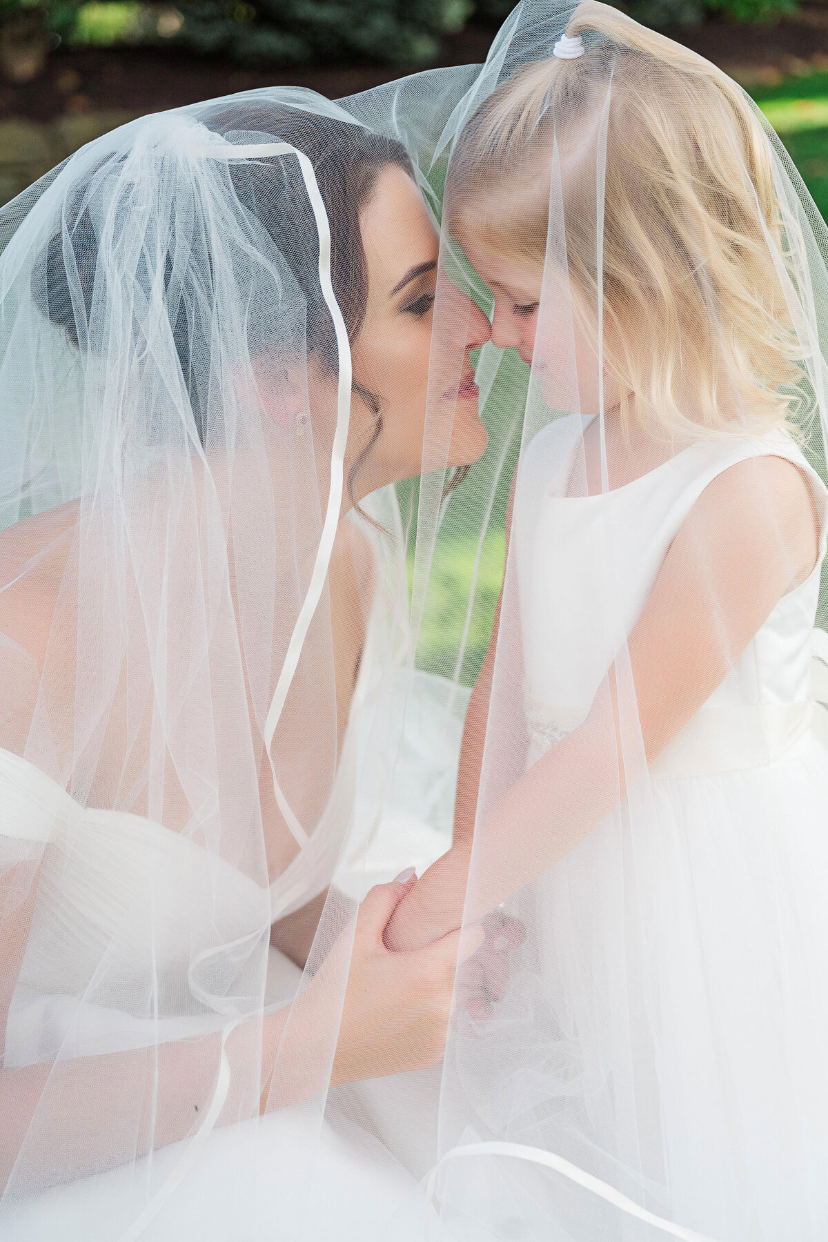 bride posing with flower girl at ohio wedding