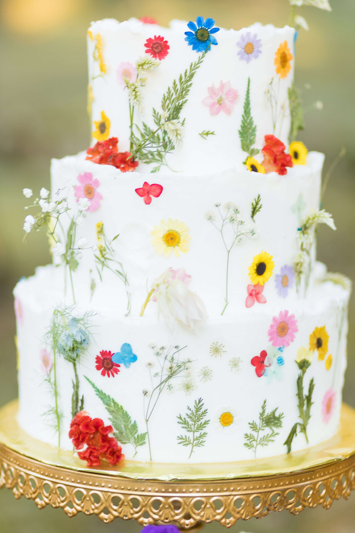 3 tiered wedding cake decorated with floral patterns