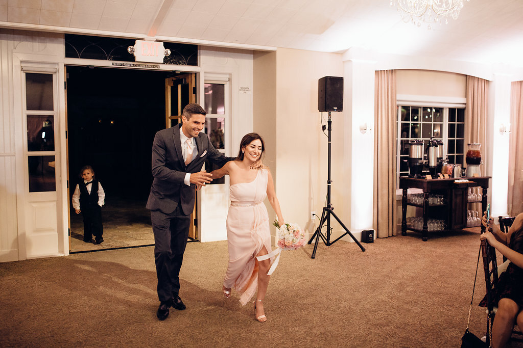 Wedding Photograph Of Groomsman Holding The Bridesmaid Inside The Reception Hall Los Angeles
