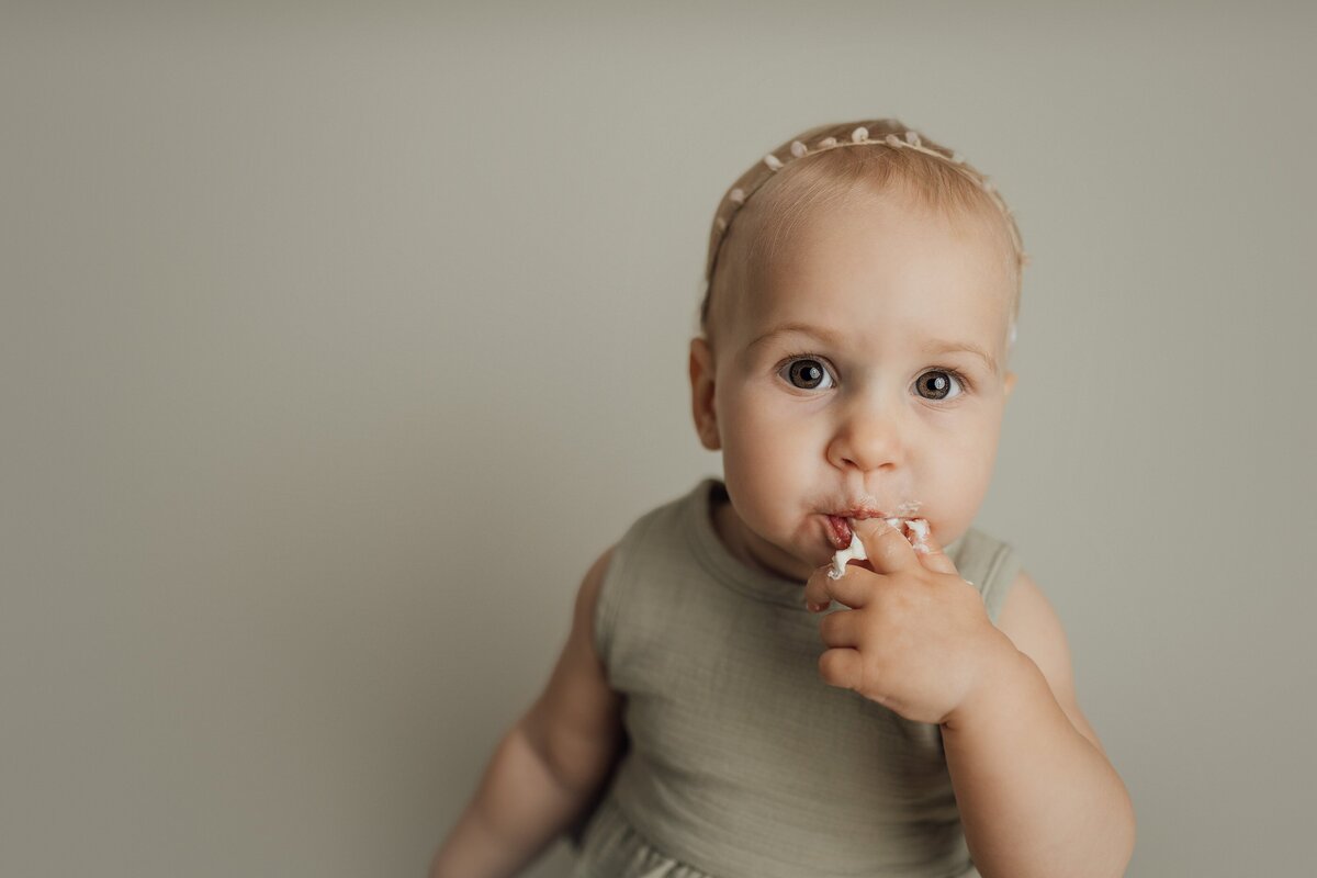 girl eating cake during cake smash session in st. pete