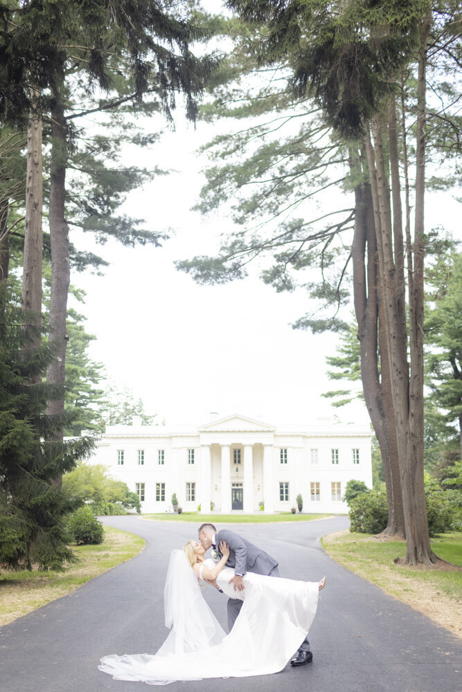 groom dipping the bride for a kiss - Wadsworth Mansion wedding photographer Rachel Girouard