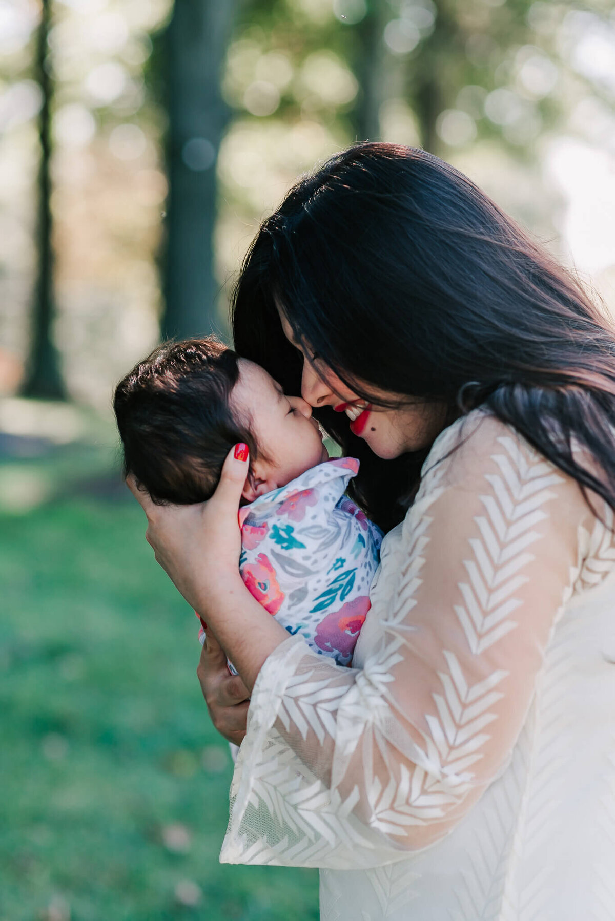 mother showing love to her baby girl during her northern VA newborn photos