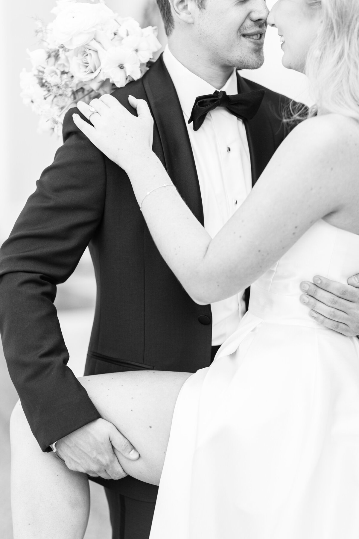 Close up of groom holding his bride close to him representing romantic Boston wedding pictures