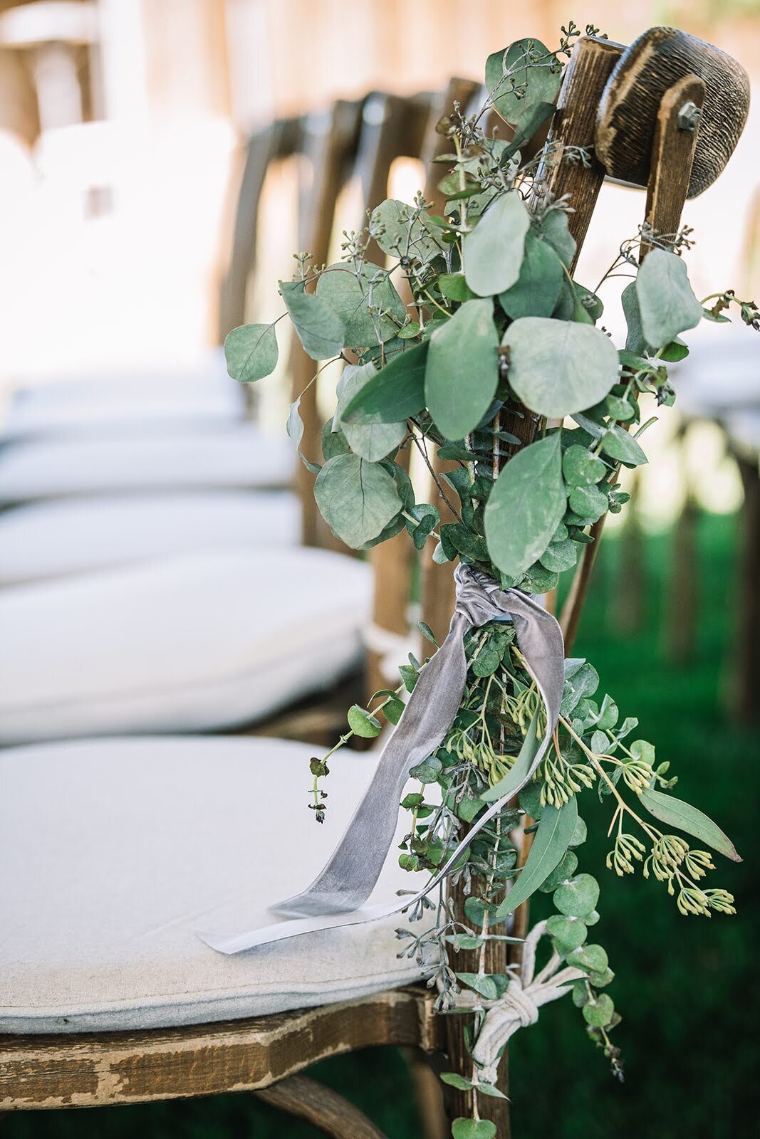 Greenery chair hangs at a wedding ceremony in Colorado done by Plantus Potum.