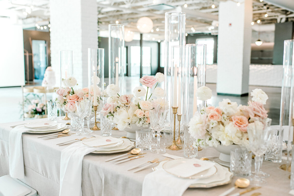 Classic and elegant reception table with pink and white florals at The Brownstone, modern and elegant Calgary, Alberta wedding venue, featured on the Brontë Bride Vendor Guide.