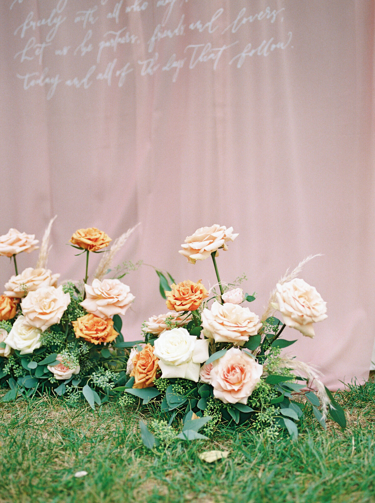 Gorgeous orange and pink wedding florals by Lovella Lifestyle, whimsical and romantic Edmonton wedding florist, featured on the Brontë Bride Vendor Guide.