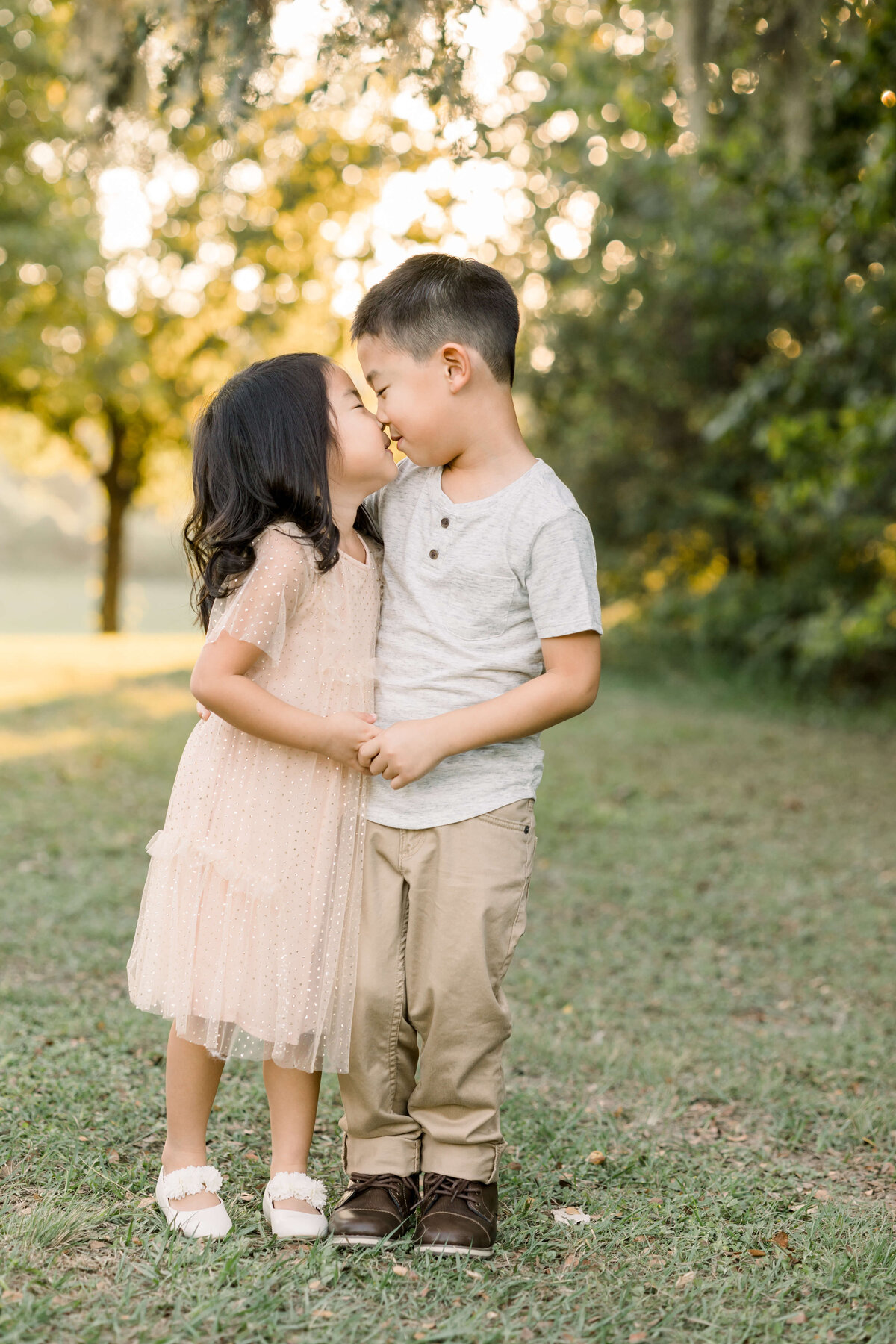 two siblings giving each other a kiss