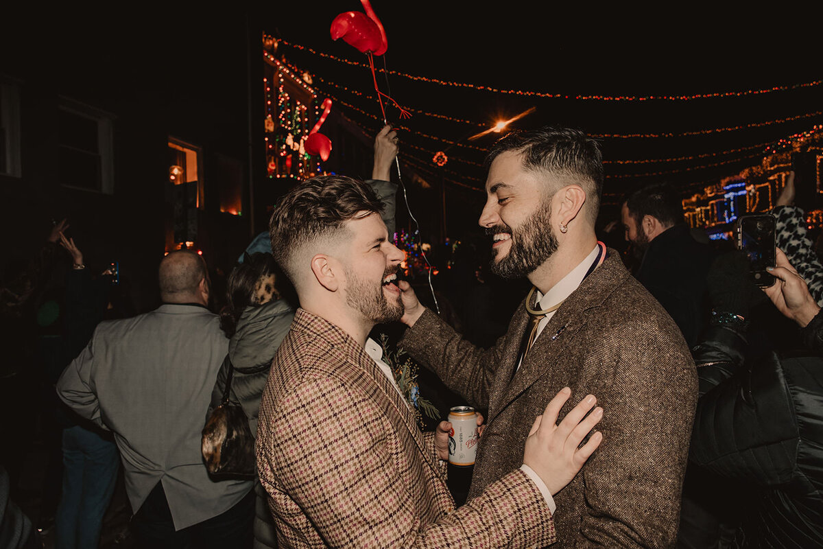 A wedding couple laughing and dancing at their reception 