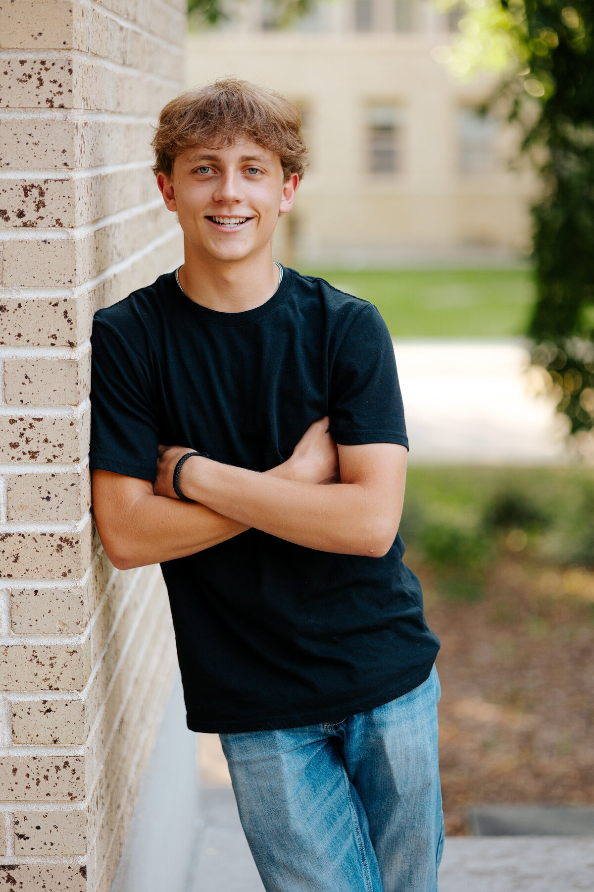 A high school senior poses for a photo during his high school senior portrait session.