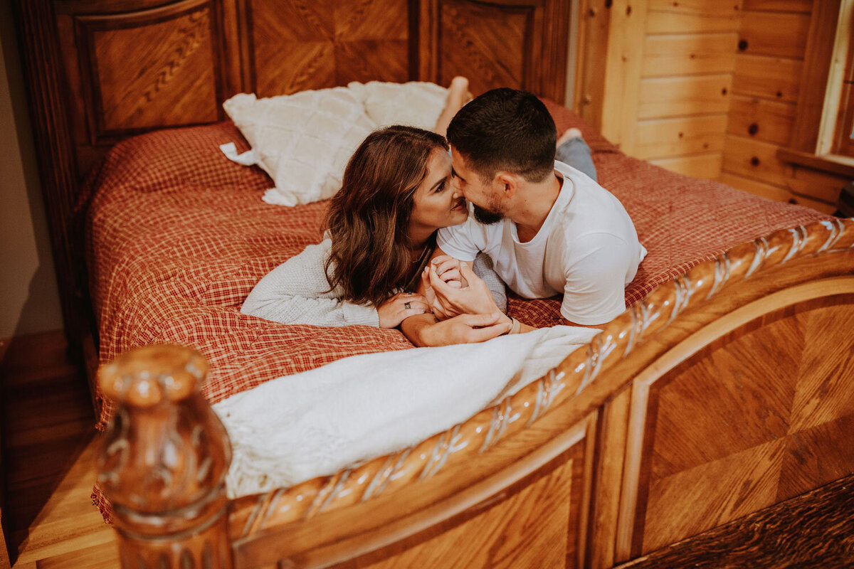 Couple sharing an intimate moment on a wooden bed
