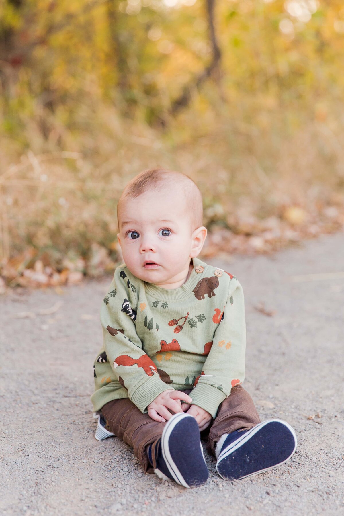 baby boy sitting  on ground