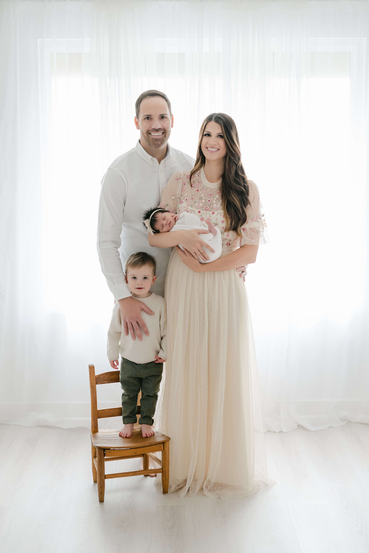 Backlit family of 4 newborn photo