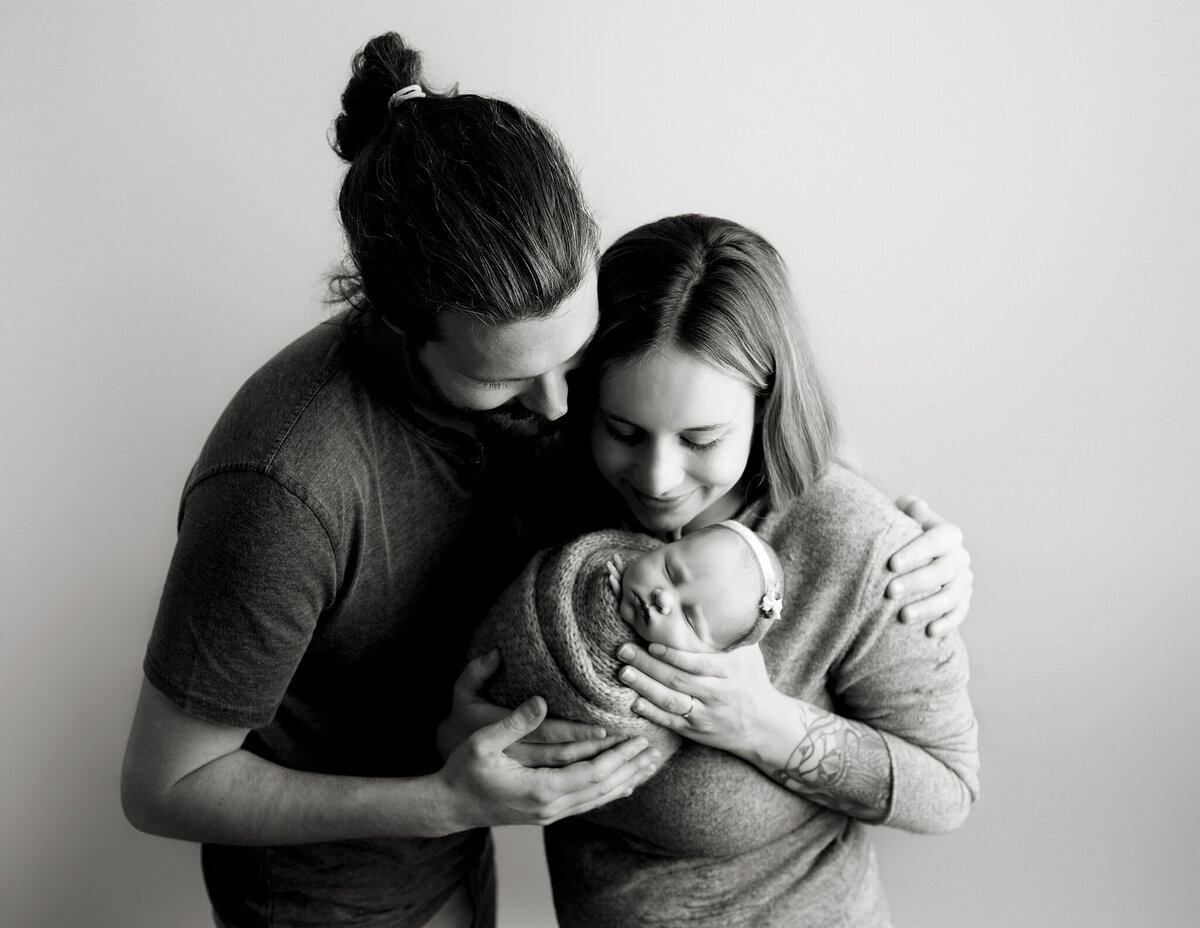 parents holding their baby in denver newborn photography studio
