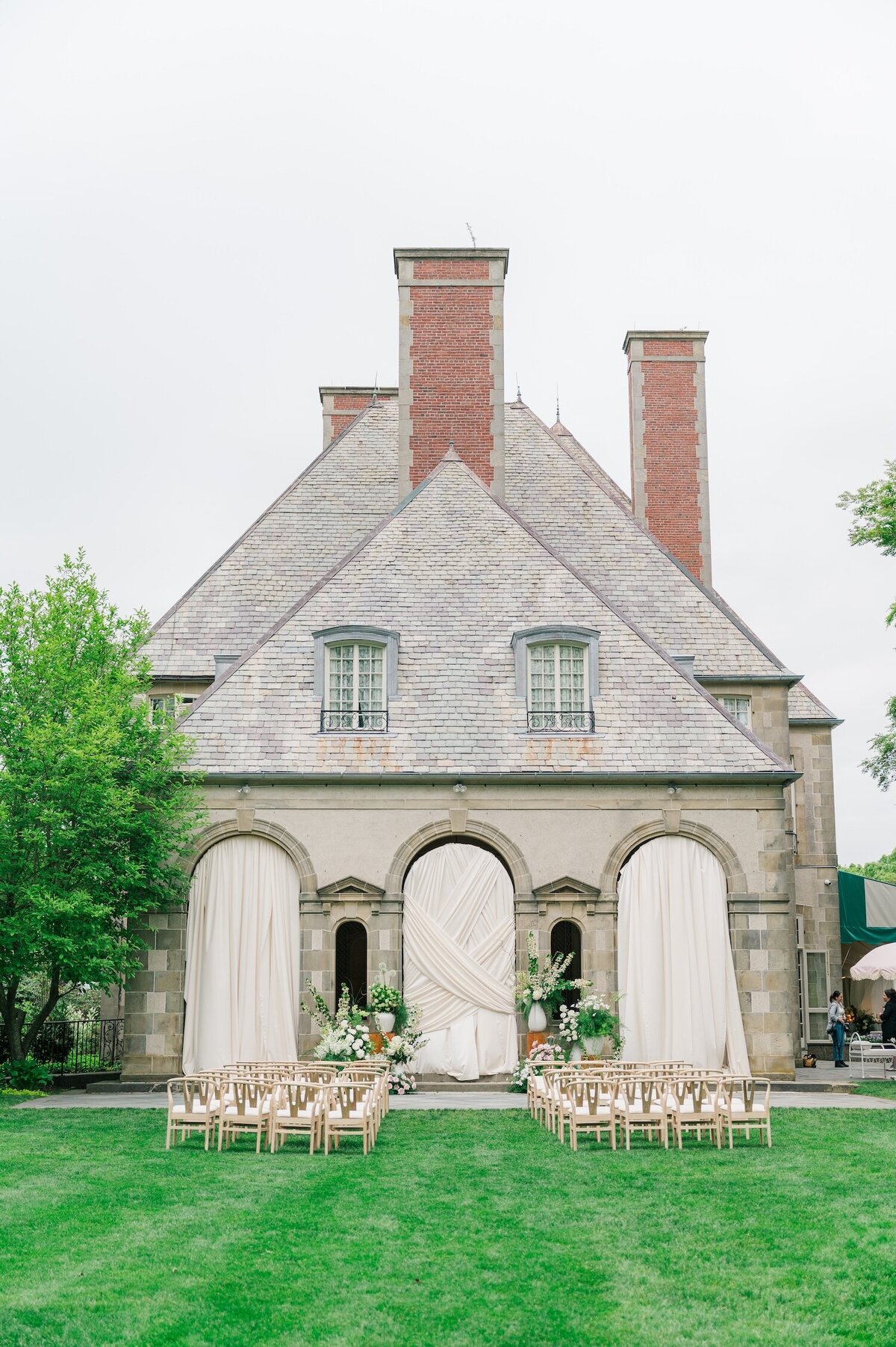 The exterior of Glen Manor House with drapery and a ceremony setup. 