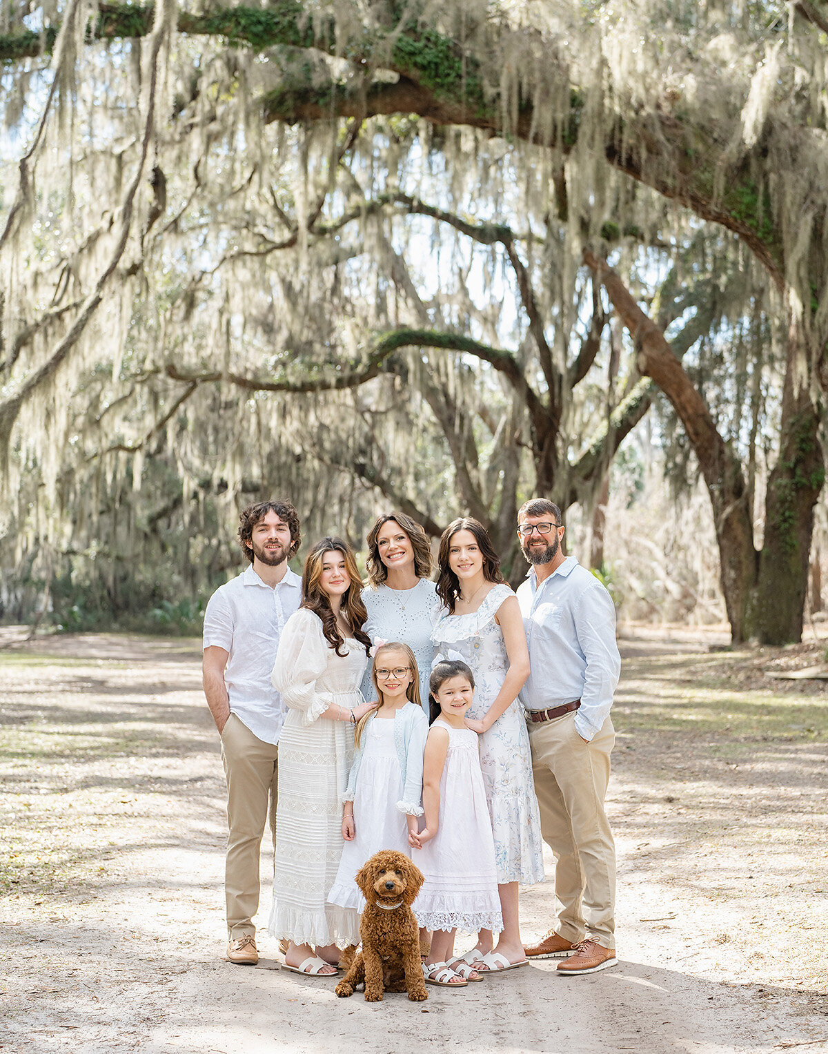 family photographed in st simons island under live oak trees on a sunny day