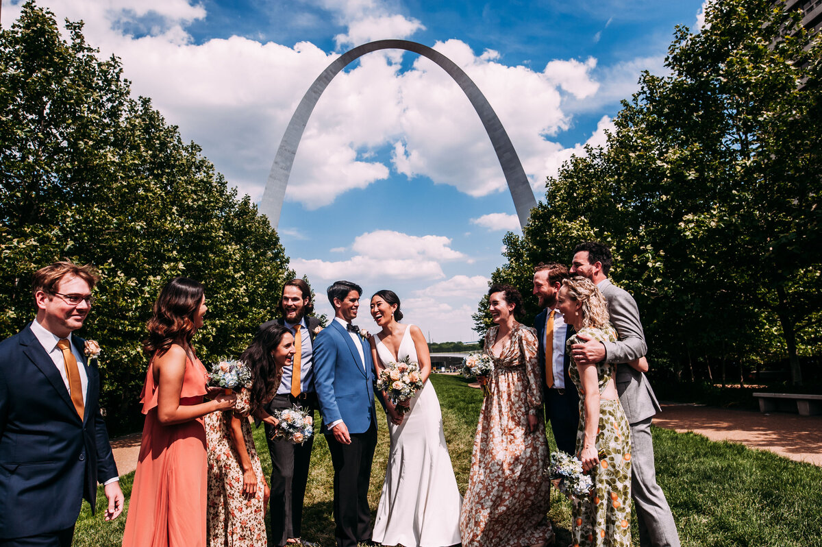 bride groom and friends under the st louis arch