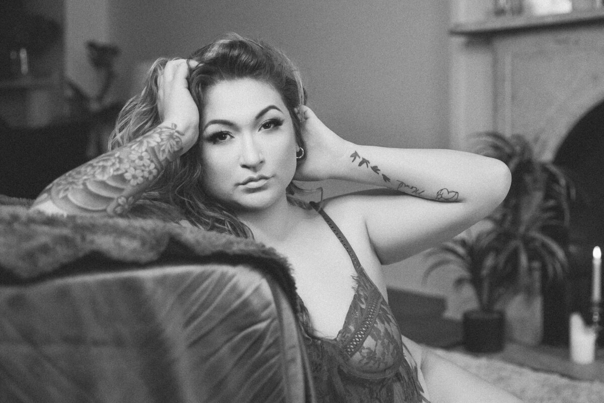 Woman playing with her brown hair in black and white photo