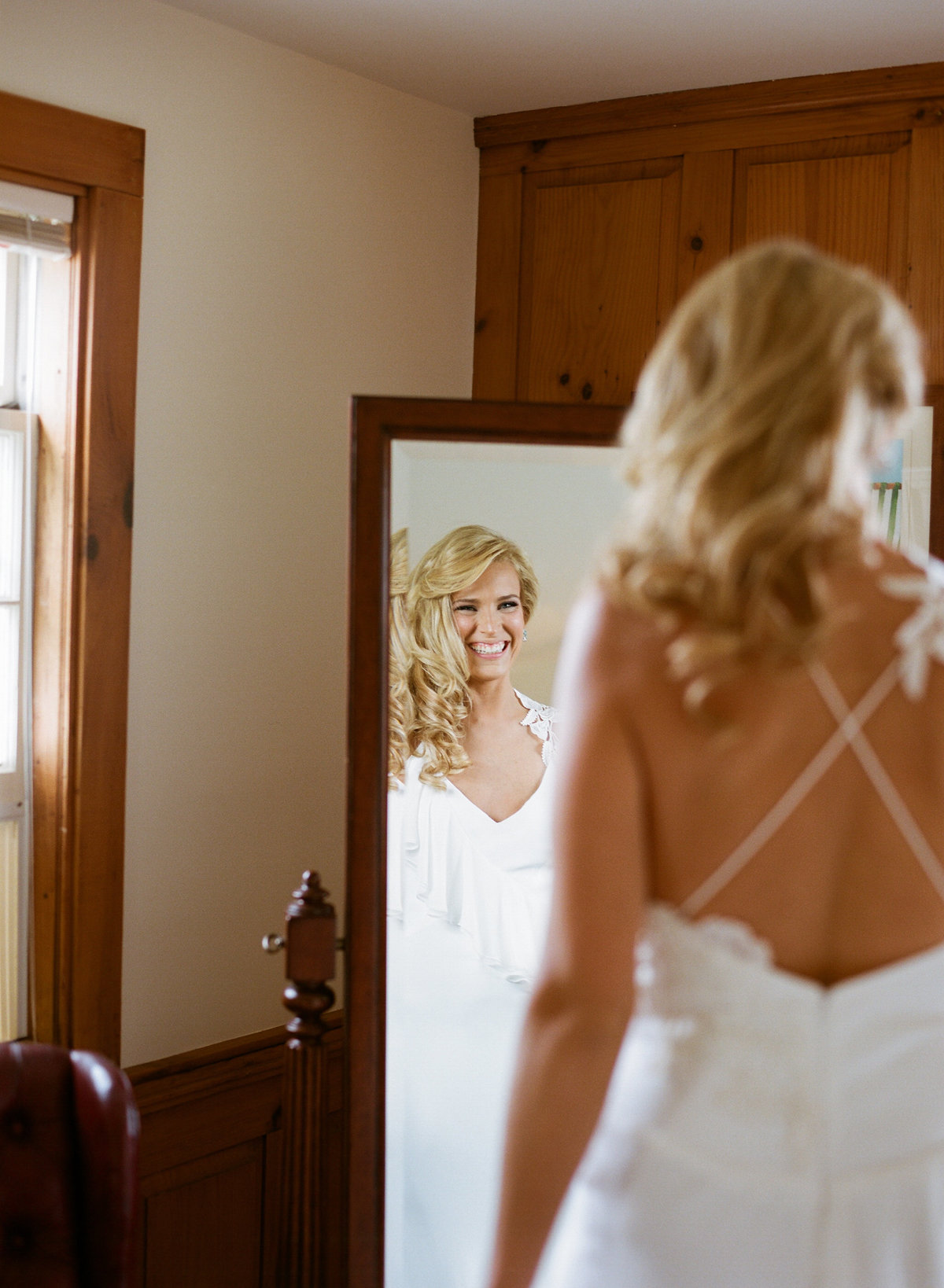 Bride looks at self in mirror