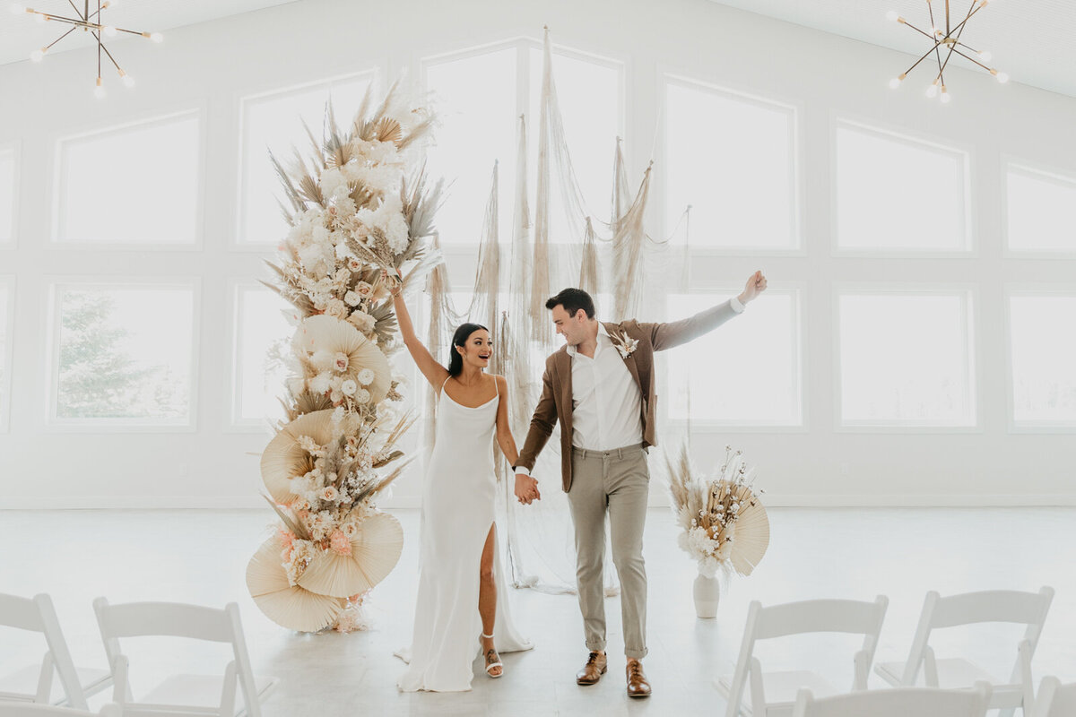 Elegant white florals and boho inspired bridals at Tin Roof Event Centre, a modern wedding venue in Lacombe, Alberta, featured on the Brontë Bride Vendor Guide.