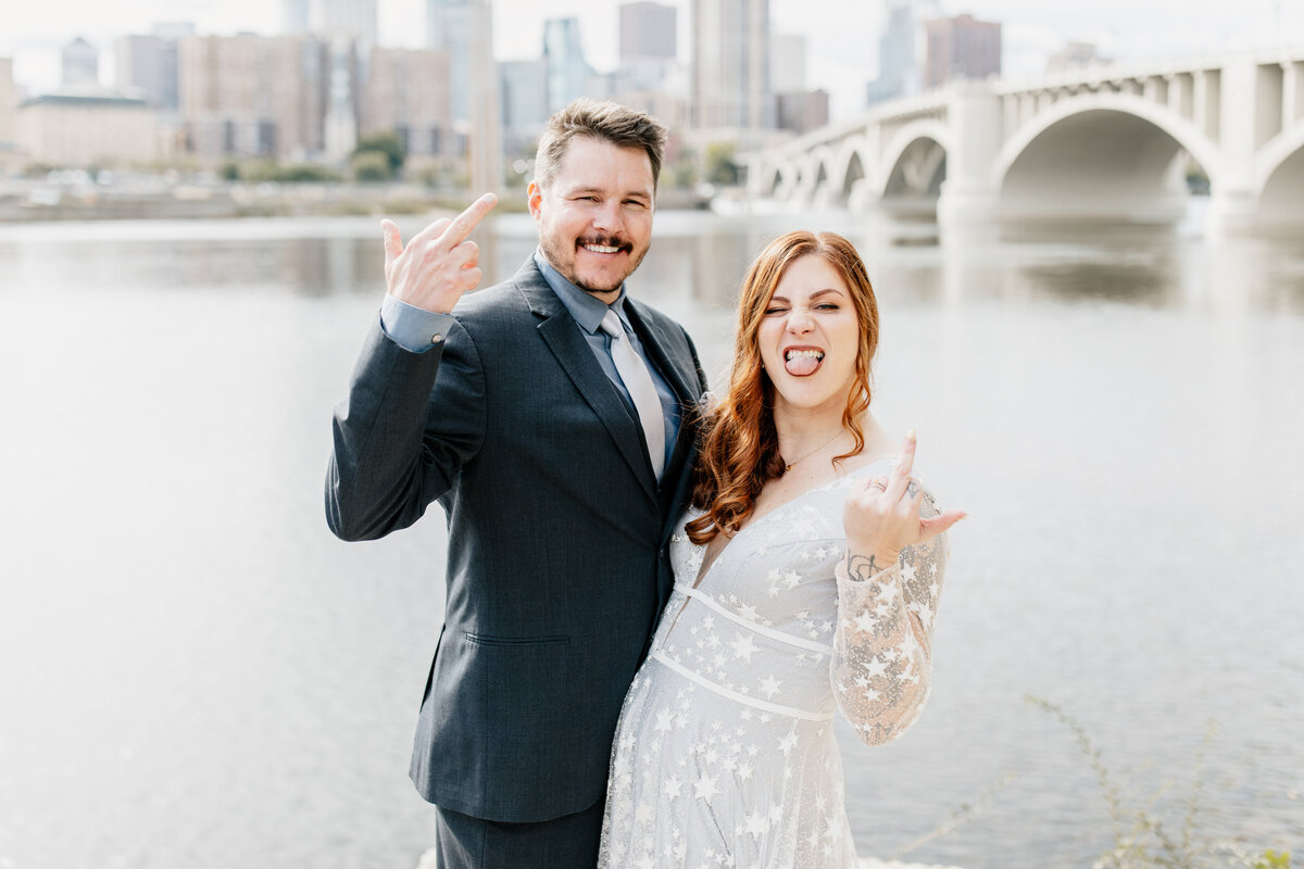 A couple takes portraits during their Minnesota wedding on Saint Anthony Main in Minneapolis, MN. Photo taken by Minnesota Wedding Photographer, Morgan Elizabeth Photography www.morganelizabethphoto.com @morganelizabethphotos