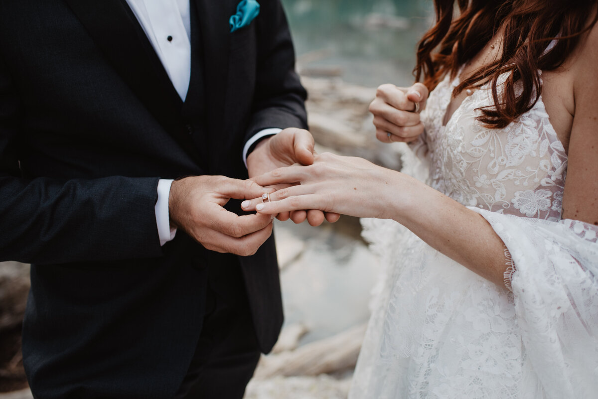 Jackson Hole Photographers capture groom putting ring on bride's finger