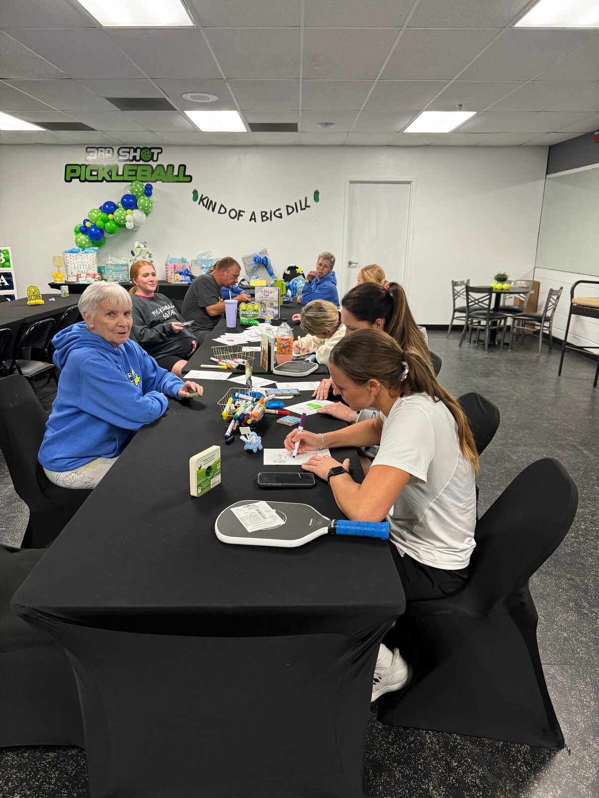 Smiling guests seated at decorated tables in the spacious party room, ideal for any celebration in Evansville, Indiana.
