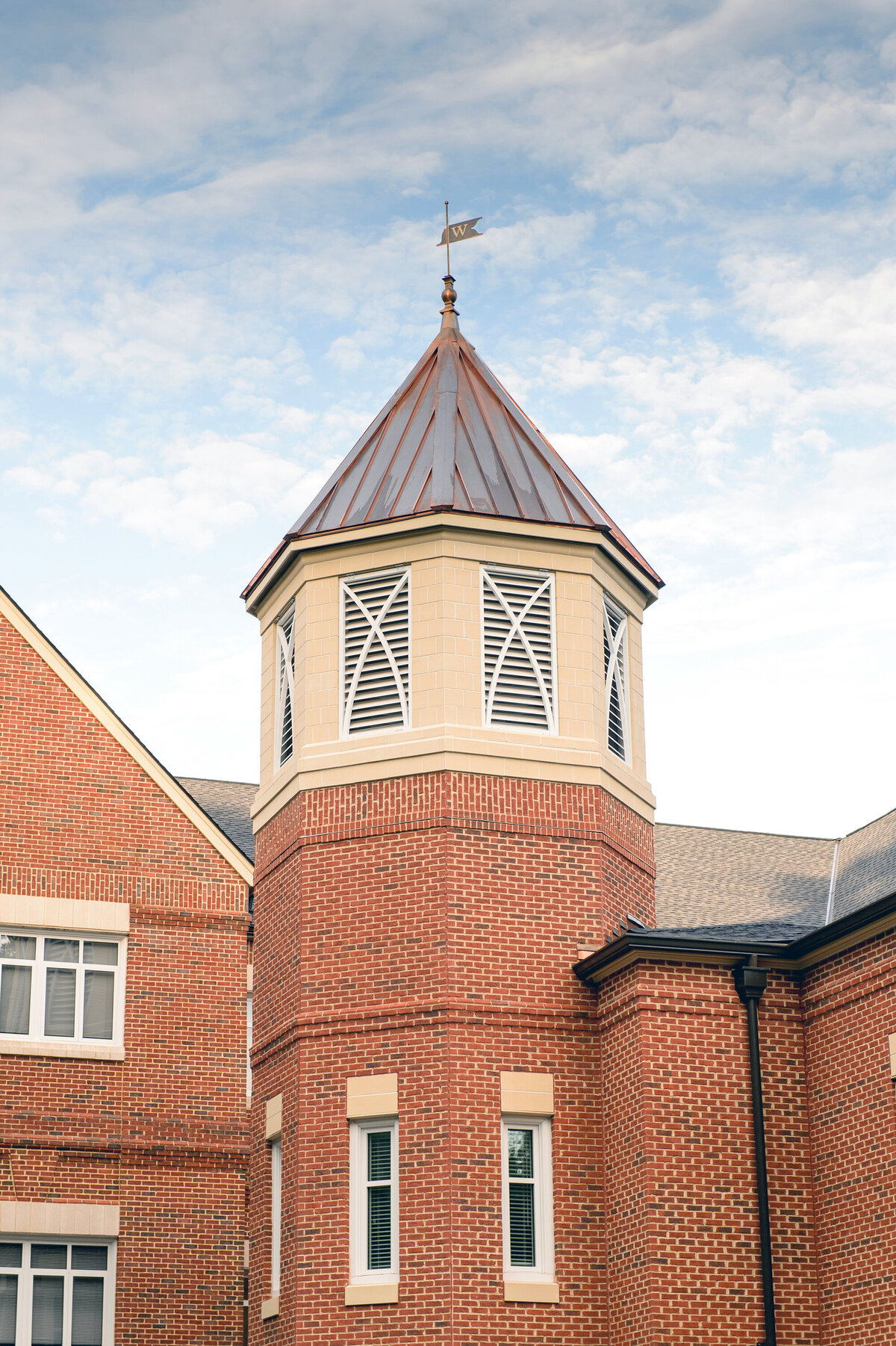 view of the brick tower at Cleghorn Hall at Wesleyan School with copper roof