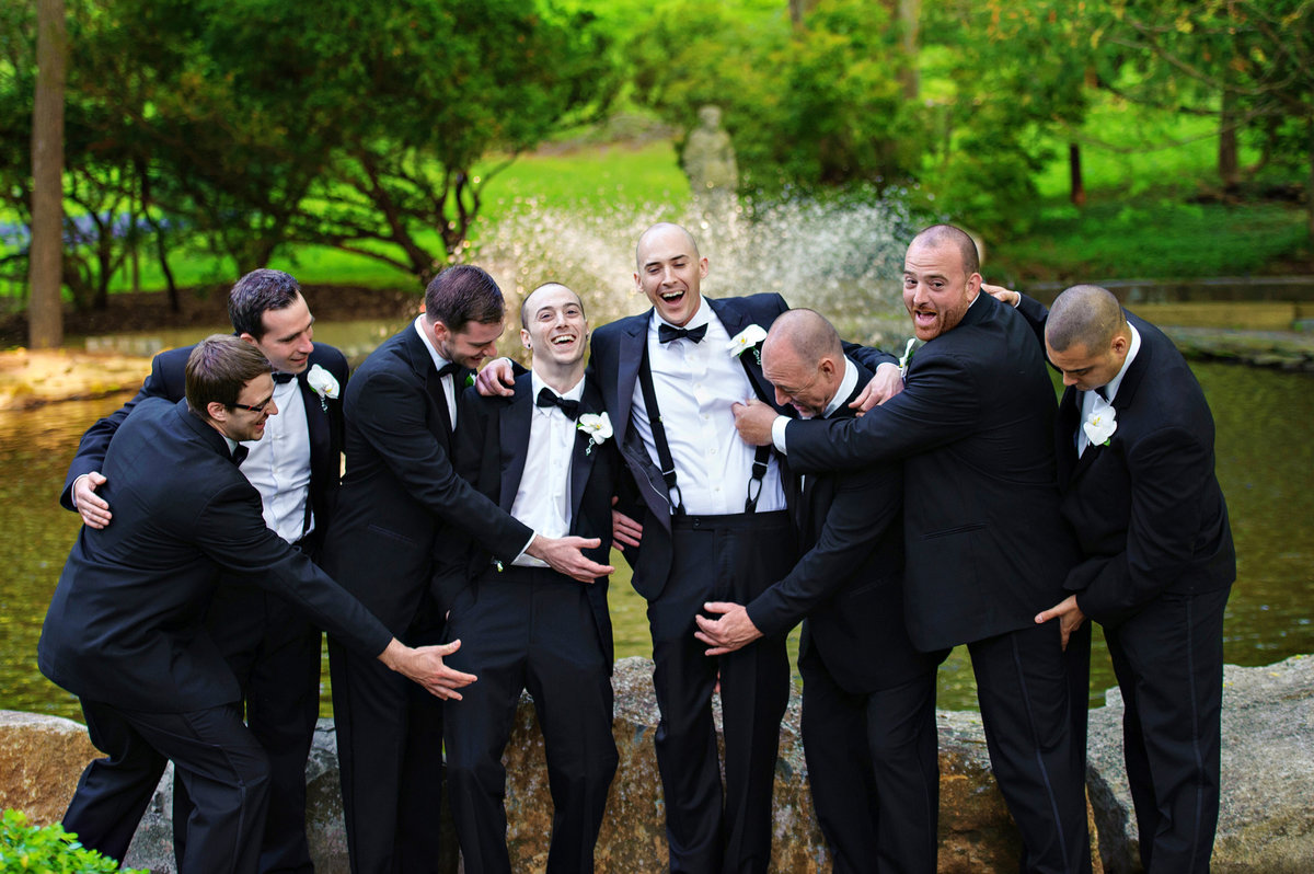 Groomsmen having fun with the groom at Holly Hedge Estate.