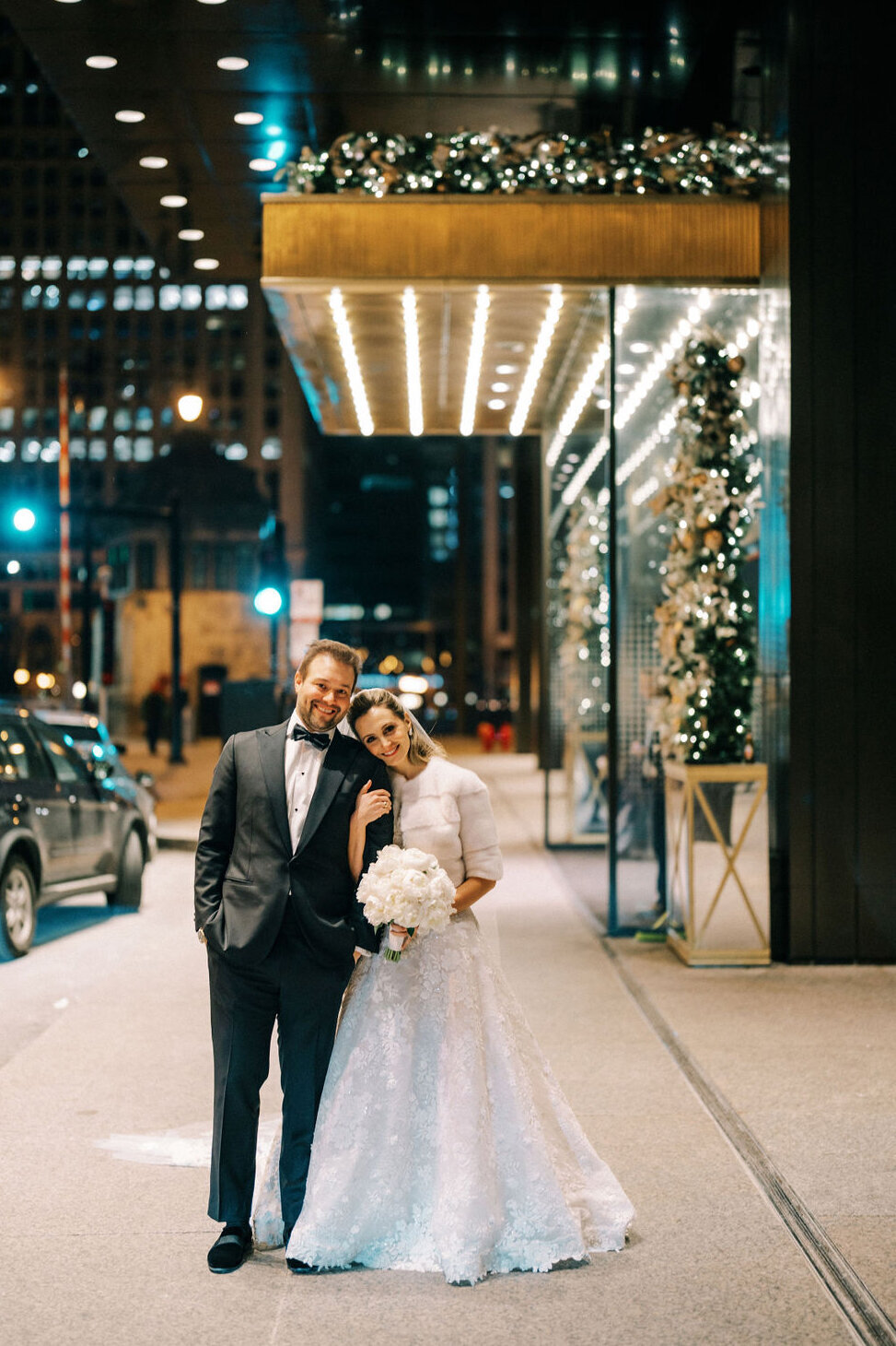 Bride and groom standing together outside The Langham Chicago. 
