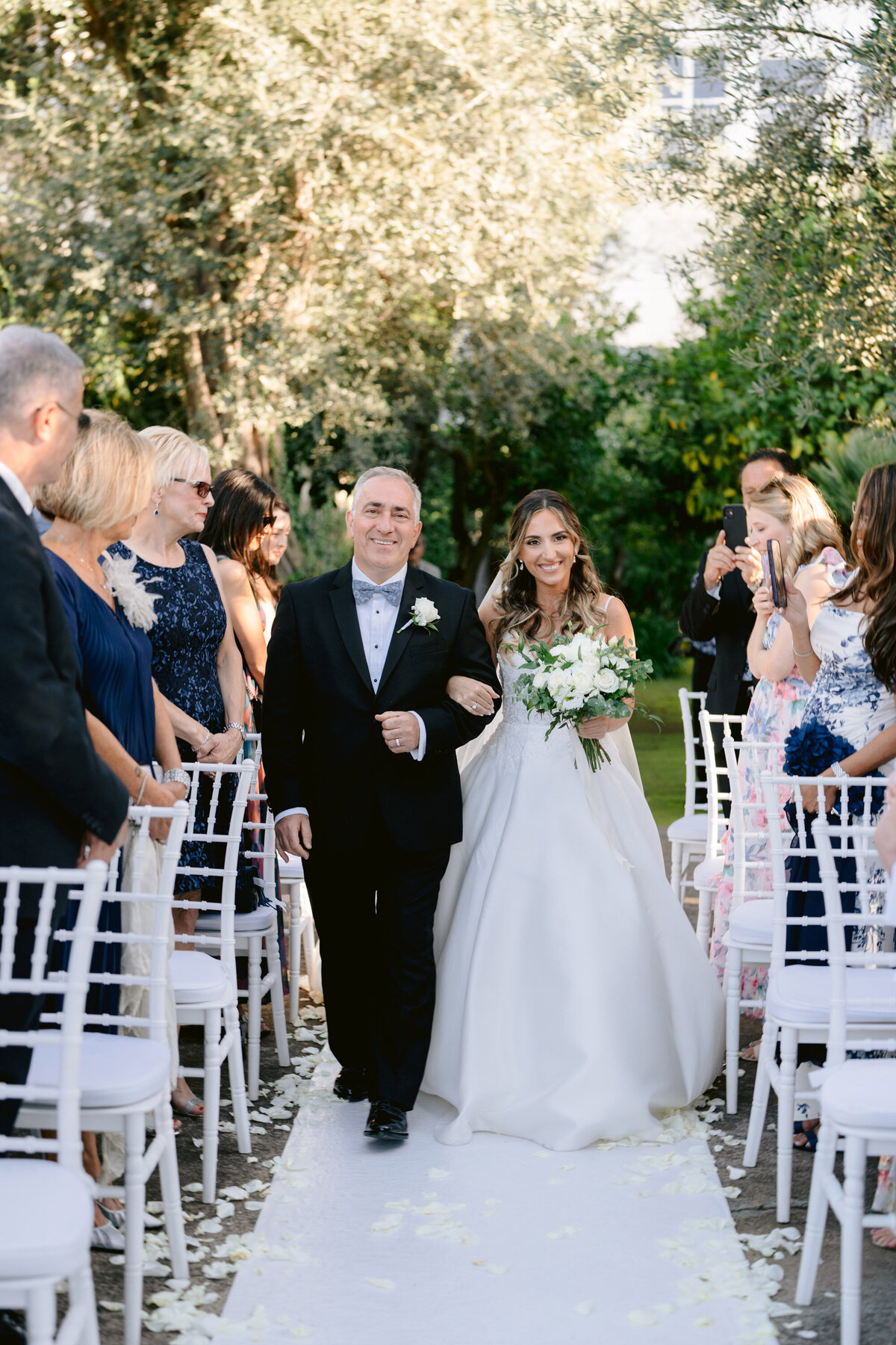 brides father is walking her down the aisle