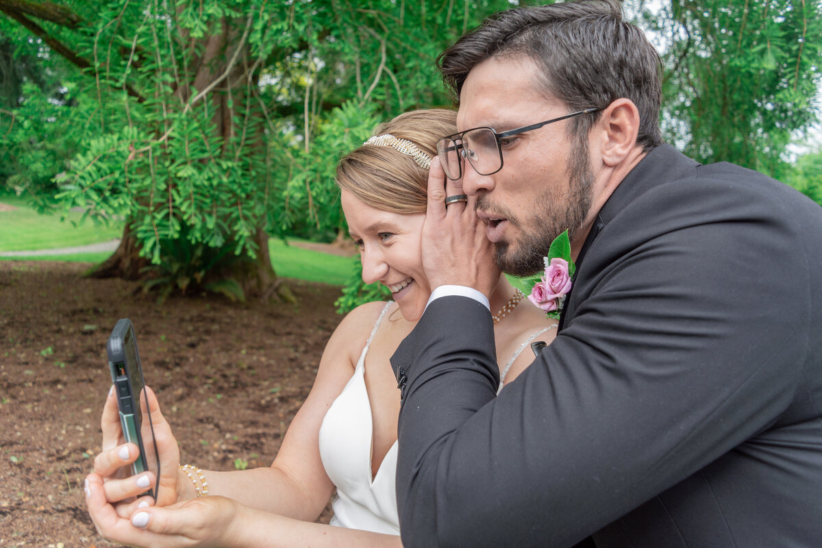 bride and groom with cell phone during the wedding