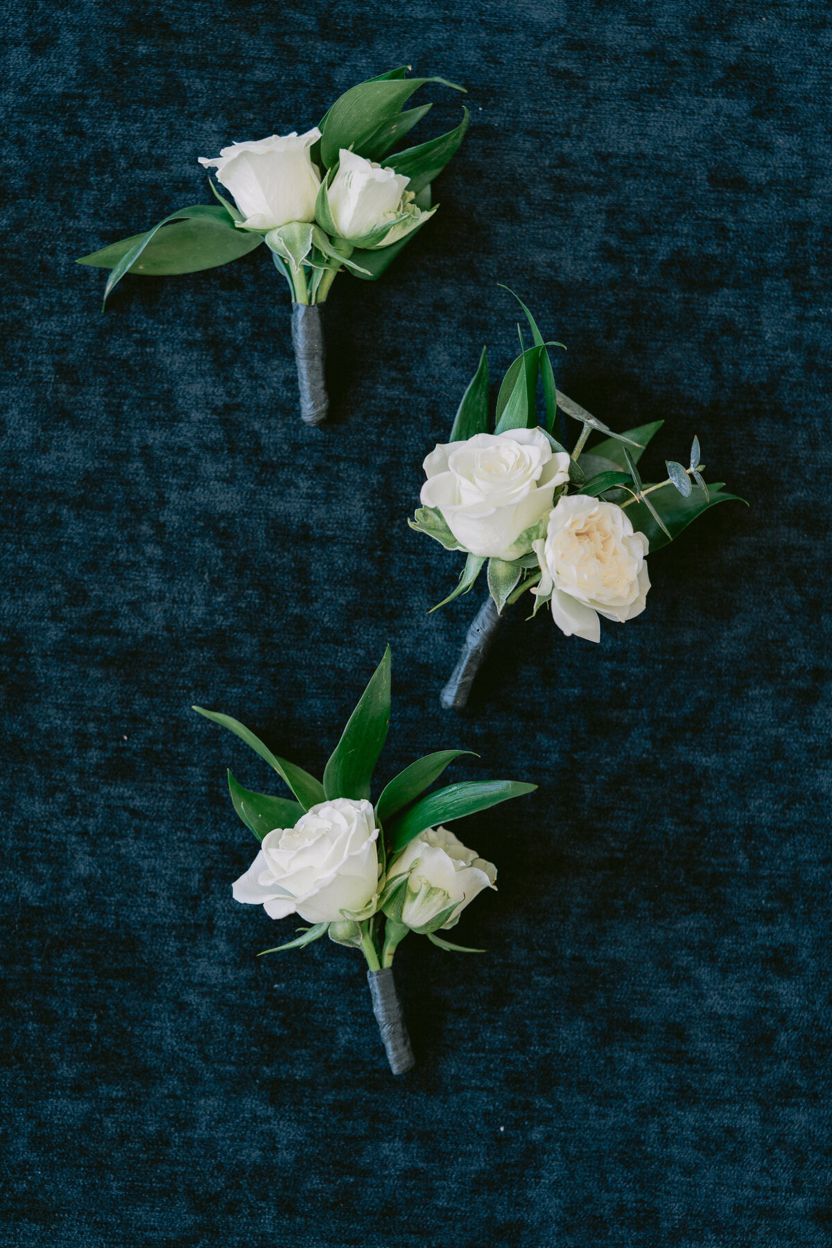 Wedding boutonnieres with ivory roses