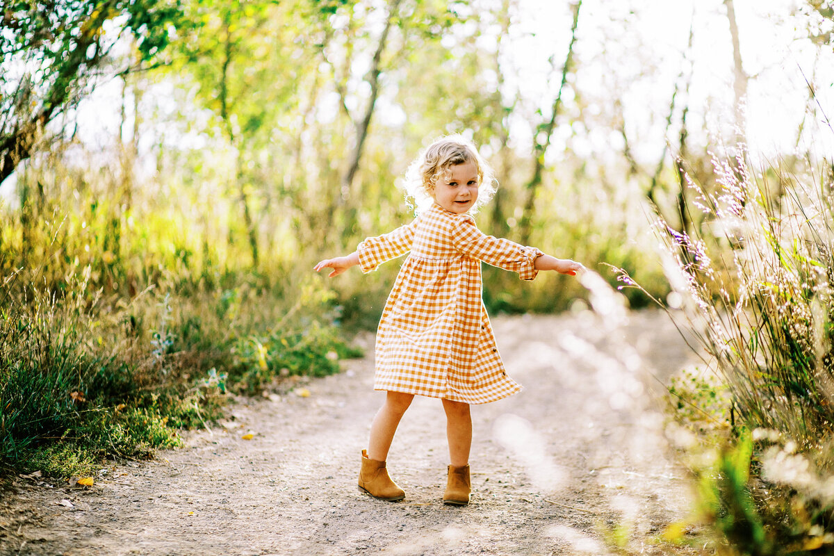 a girl spins during a fall photo session